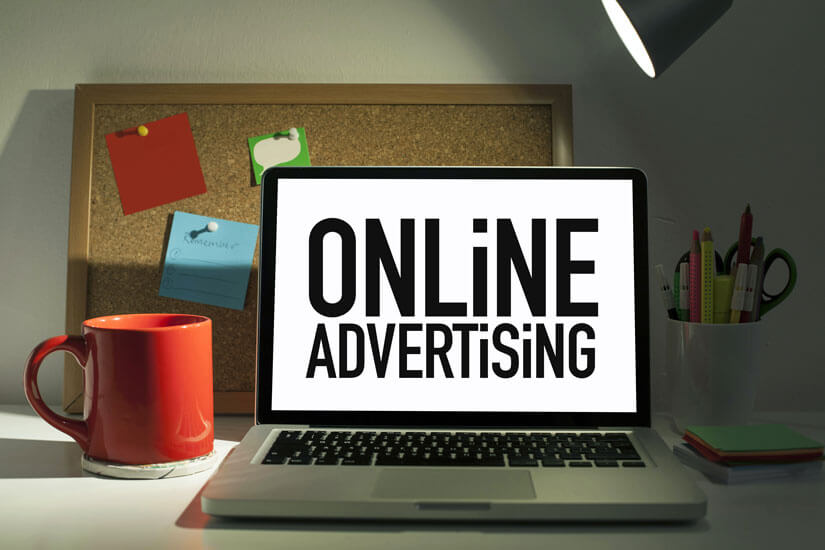 Online advertising words displayed on laptop screen